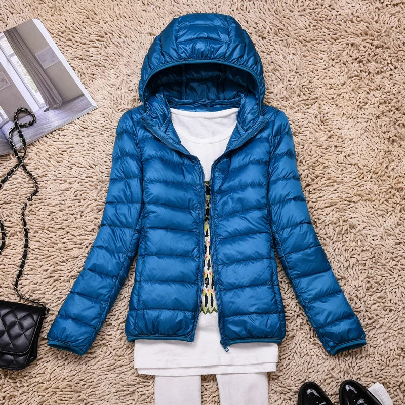 Stylish women's hooded puffer jacket, ultralight & packable. Perfect for fall adventures & winter warmth.