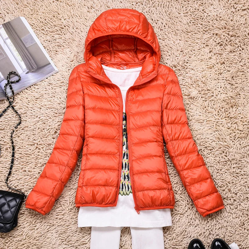 Cozy women's ultralight puffer coat. Packable, hooded design for travel, fall, & winter wear.