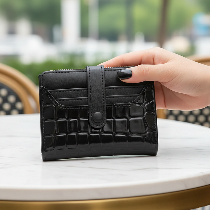 Women's compact luxury wallet with secure snap closure, perfect for everyday use.