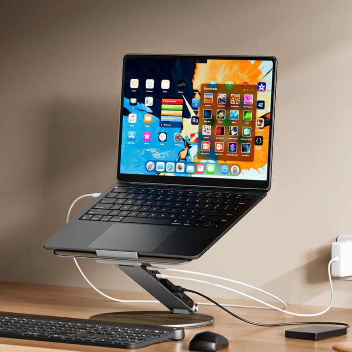 Grey USB C laptop stand with adjustable height & rotating base for an ergonomic workstation & desk organization.