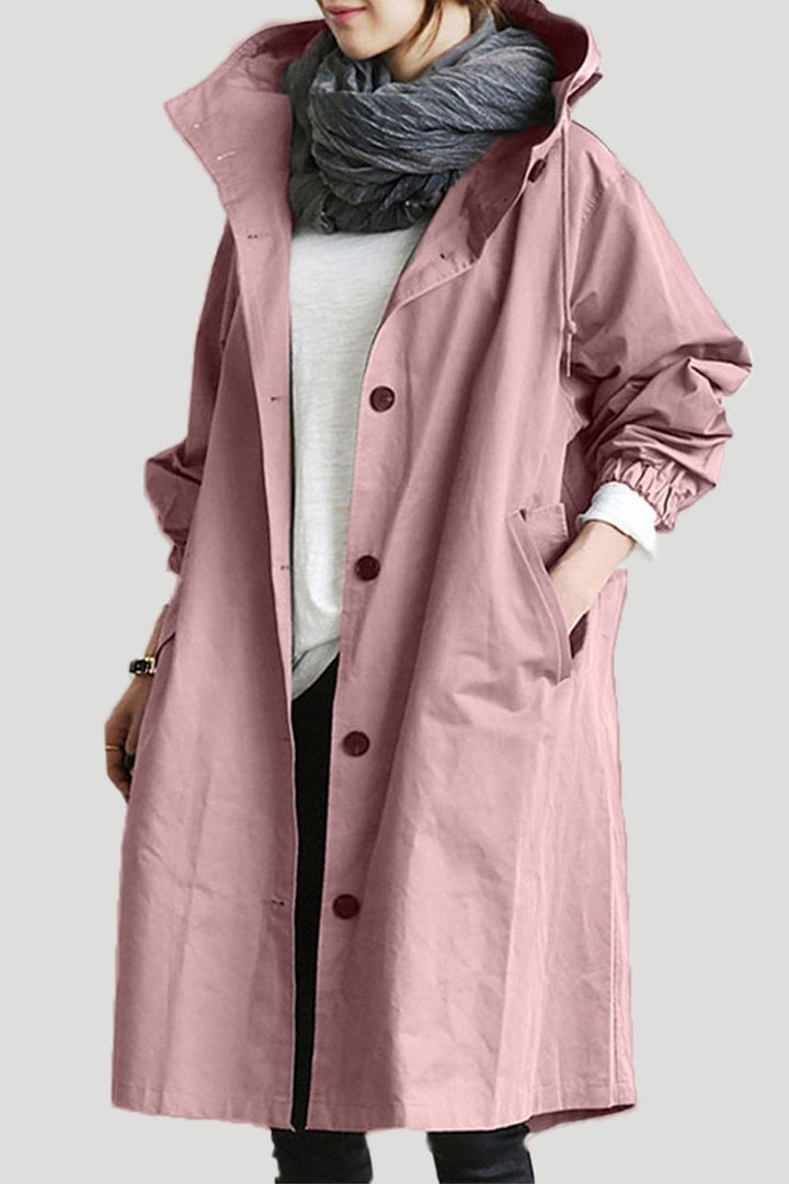 Woman wearing elegant waterproof trench coat with hood, classic fall & spring outerwear, stylish rain protection.