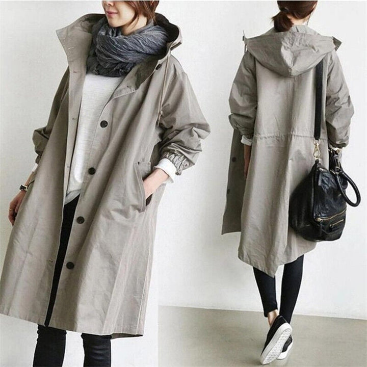 Elegant hooded trench coat for women, waterproof and classic, ideal all-weather outerwear & rain jacket.
