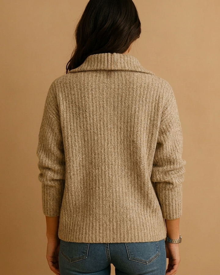 Close-up of a women's long-sleeve half-zip structured sweater, highlighting its chic fabric and comfortable fit.