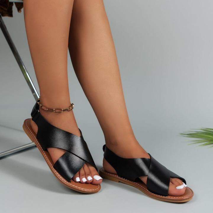 Flat open-toe women's sandals featuring an adjustable strap for everyday comfort. Ideal for casual summer & walking.
