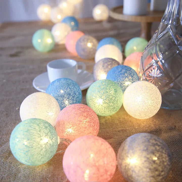 Party decor: warm LED cotton ball string lights adding a festive and inviting glow.