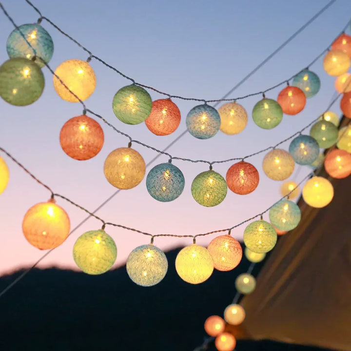 Indoor decorative warm LED cotton ball string lights providing a soft glow in a living room.