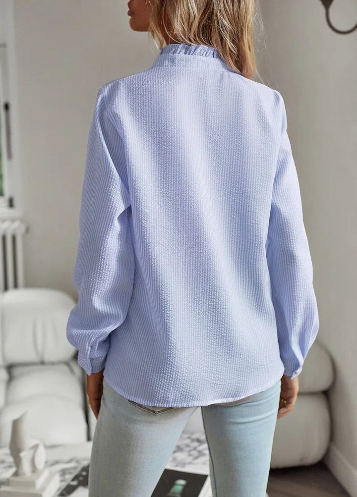 Classic white women's ruffled polo blouse, a versatile and chic top for any occasion.
