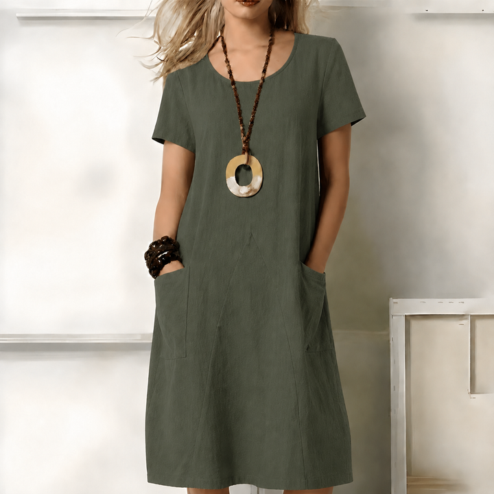 Women's relaxed fit midi dress with short sleeves and side pockets for comfortable, versatile everyday wear.