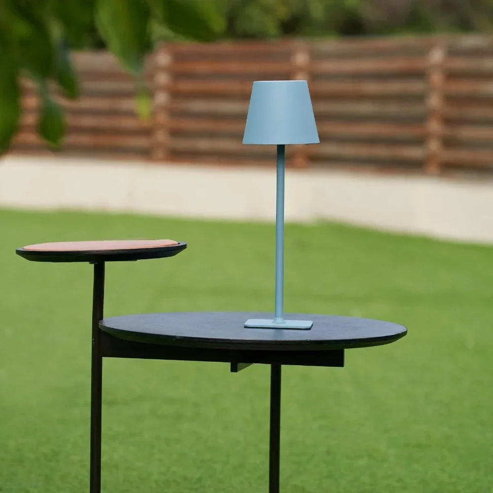Sleek modern LED table lamp, dimmable & rechargeable. Ideal for indoor & outdoor settings.