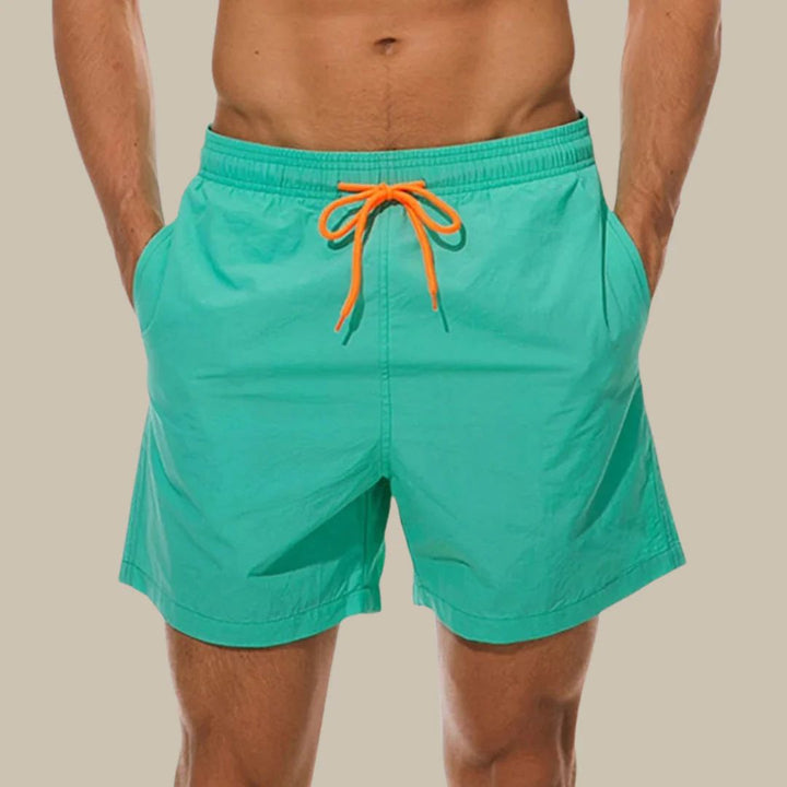 Versatile men's drawstring swim shorts in black. Features side pockets, perfect for casual summer outings, beach, or pool.