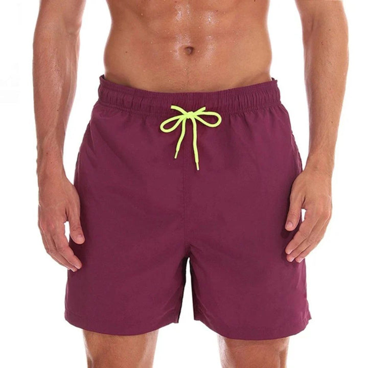 Stylish men's athletic drawstring swim shorts with pockets, perfect for summer beach, pool, or resort wear. Quick-drying.