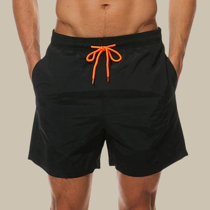 Men's blue drawstring swim shorts with side pockets, ideal for beach, pool, or casual summer wear. Quick-dry fabric.