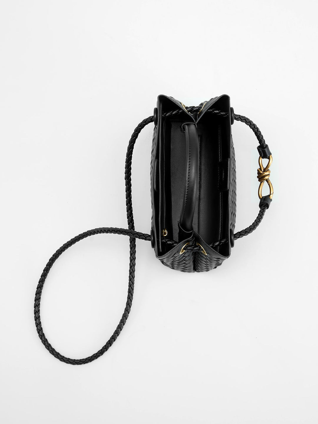 Versatile women's woven top handle bag with elegant twist accent, a perfect chic fashion accessory for outfits.