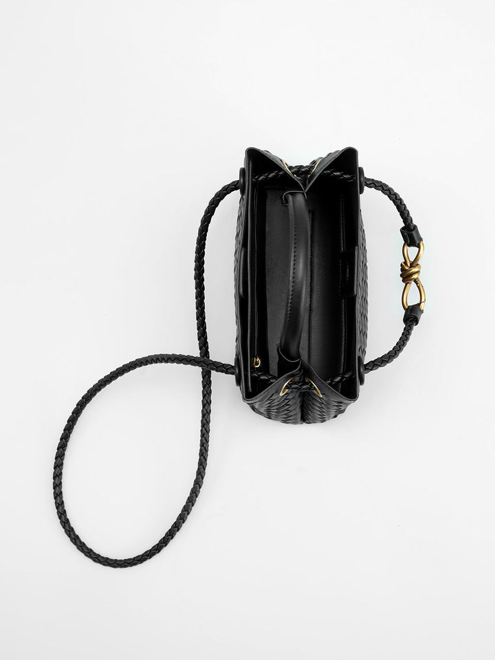Versatile women's woven top handle bag with elegant twist accent, a perfect chic fashion accessory for outfits.