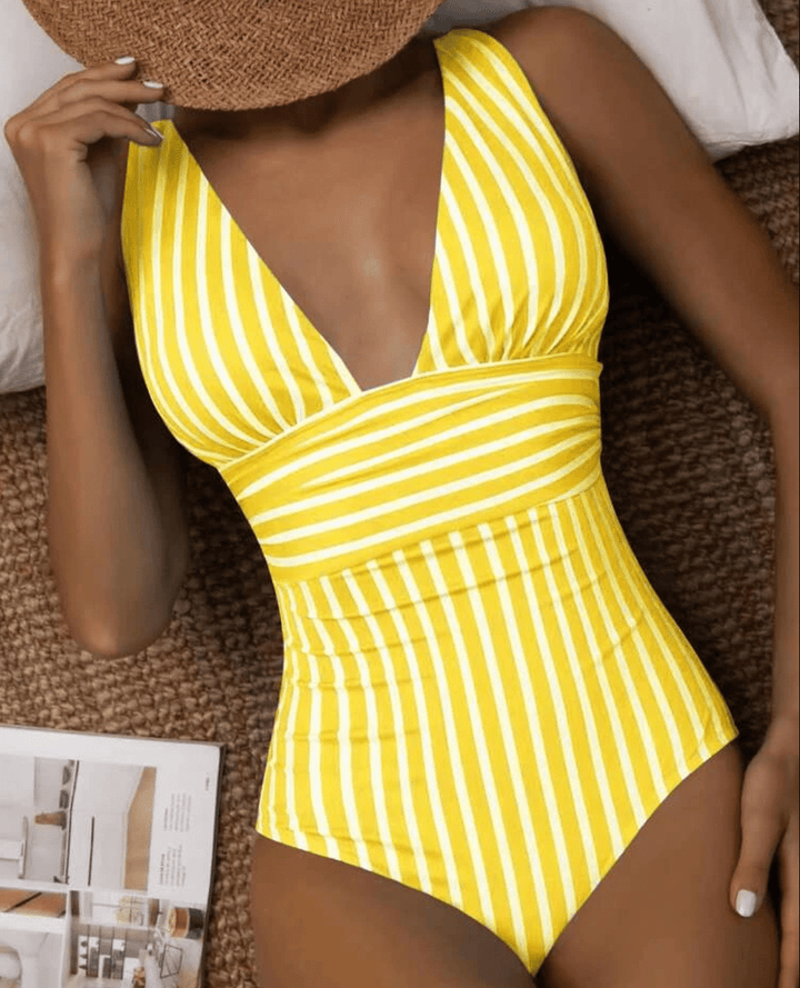 Close-up of chic striped one-piece swimsuit fabric, highlighting quality & design for summer fashion beachwear.
