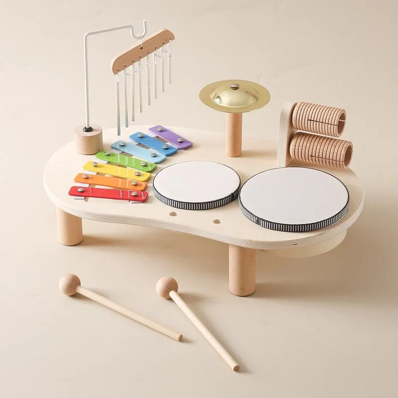 Vibrant children's musical instrument set. Toddler activity table with xylophone, drums, and bell for play.
