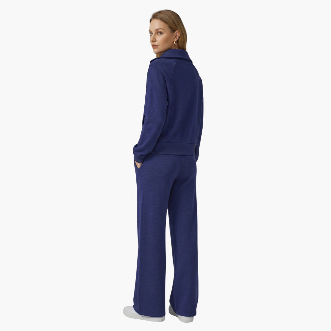Navy blue women's two-piece lounge set. Half-zip top & wide-leg drawstring pants offer comfort & style.