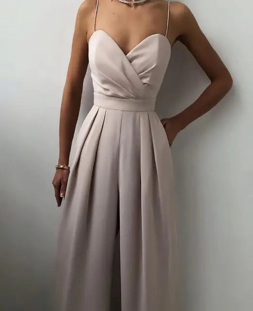 Solid color wide leg jumpsuit for women, offering comfortable and stylish evening wear.