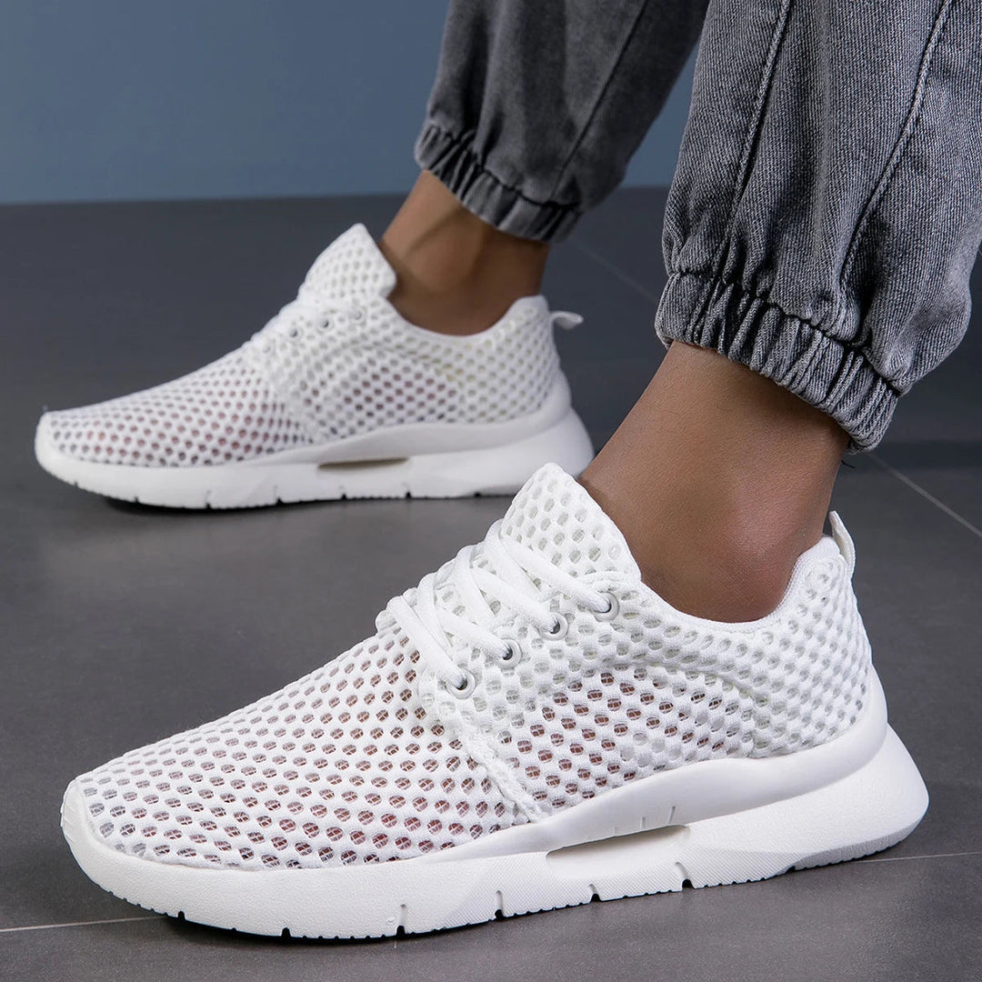 Close-up of Jaslyn unisex lightweight sneakers, highlighting breathable mesh and lace-up design for comfort.
