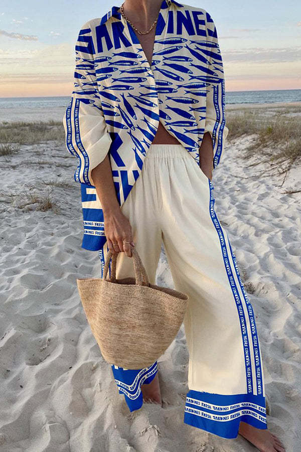 Women's blue sardine print jumpsuit for a playful summer look. Comfortable, breathable all-in-one outfit.