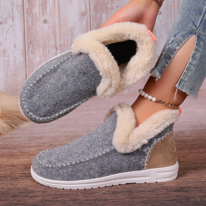 Women's foot wearing cozy orthopedic slip-on slippers. Comfortable, warm indoor footwear with great support.