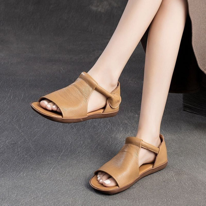 Comfortable women's flat sandals, open toe design & secure ankle strap for everyday style.