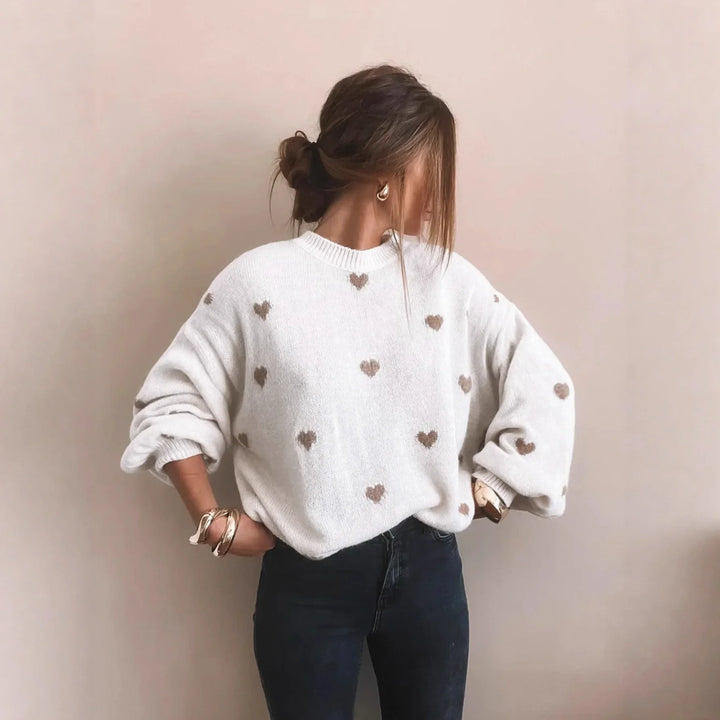 Women's cozy oversized jumper with charming heart embroidery & puff sleeves. Perfect for fall style.