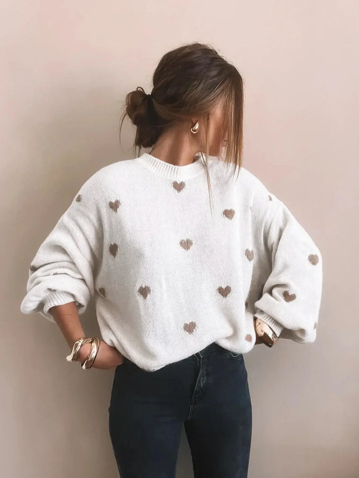 Chic women's oversized sweater with puff sleeves & intricate heart embroidery, ideal for cozy days.