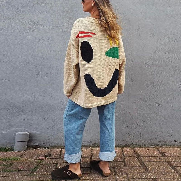 Comfortable women's oversized smiley face knit sweater in a loose fit, ideal for fall and winter style.