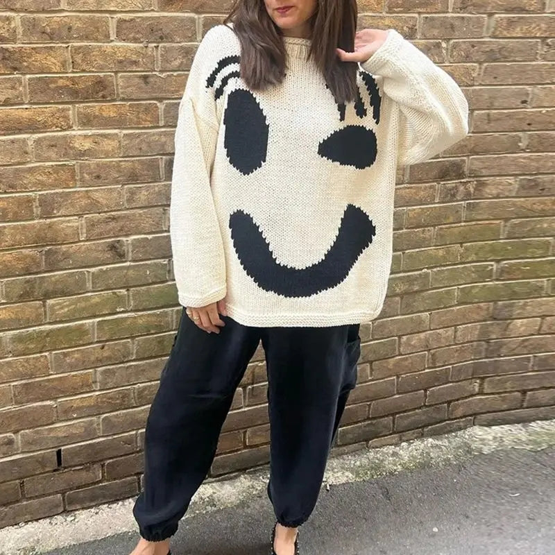 Comfortable women's oversized smiley face top, a cozy knit sweater for a relaxed and trendy everyday look.