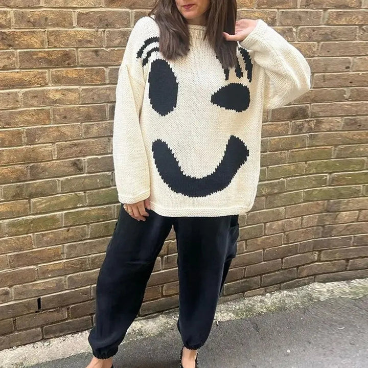 Comfortable women's oversized smiley face top, a cozy knit sweater for a relaxed and trendy everyday look.
