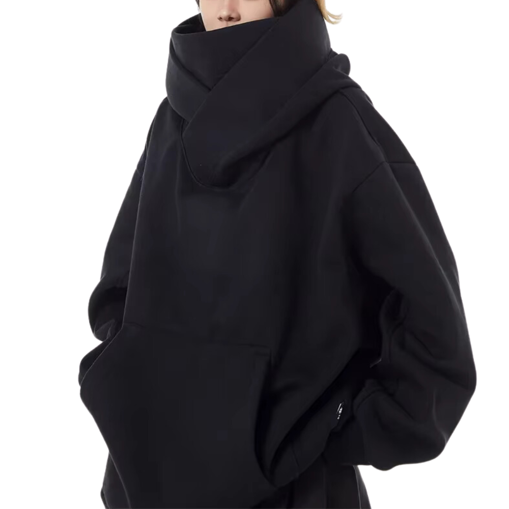 Side view of a woman wearing a relaxed fit black oversized turtleneck sweatshirt with stylish dropped shoulder.