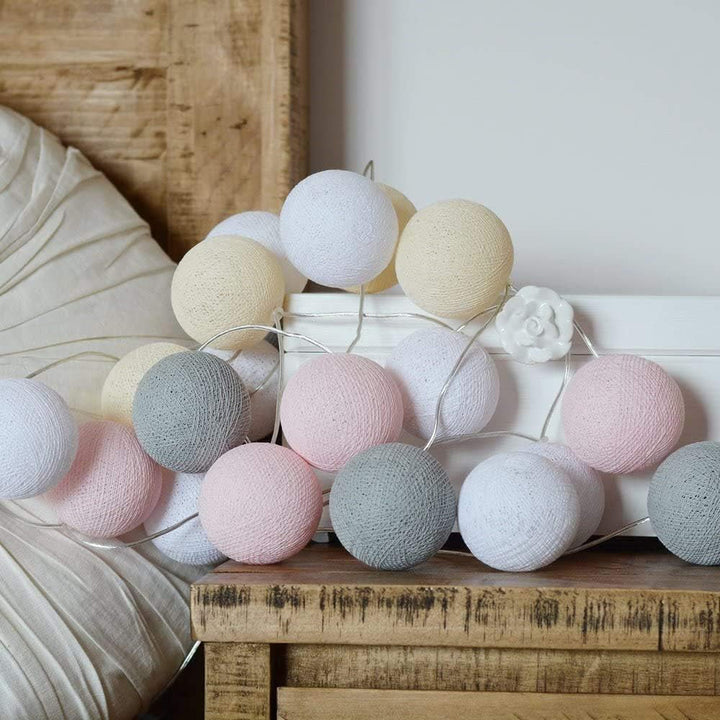 USB-powered warm LED cotton ball fairy lights arranged artfully on a mantelpiece.