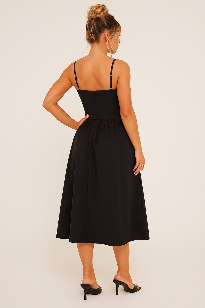 Women's black midi dress with elegant pleats & skater skirt, ideal for occasion wear. Front view, ready for a formal party.