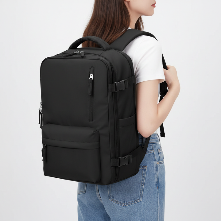Person wearing a versatile black rolling travel backpack on their back, demonstrating its comfortable shoulder straps.