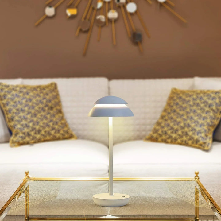 Nordic minimalist LED table lamp glowing in a modern living room, cordless accent lighting, rechargeable.