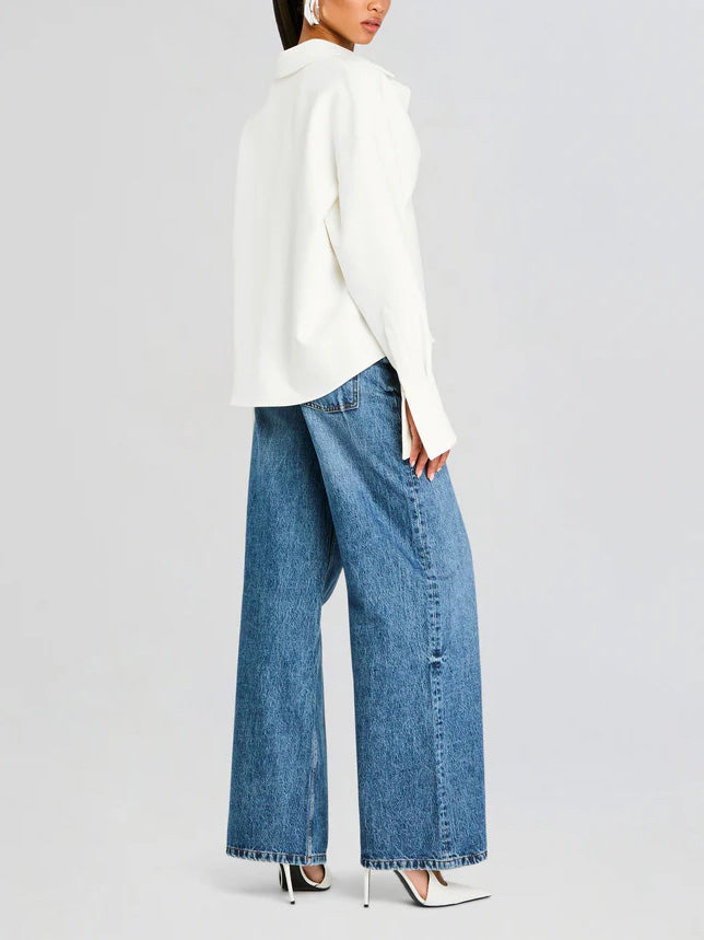 Chic women's white button-down shirt with elegant drape. Long sleeve blouse, a modern classic for women's fashion.