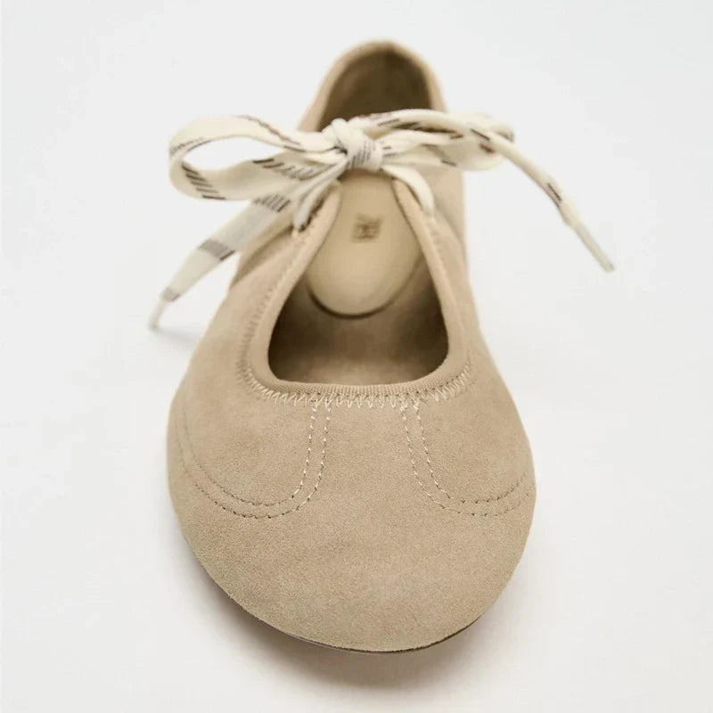 Detail shot of the laces on comfortable women's ballet flats, emphasizing secure fit and style.