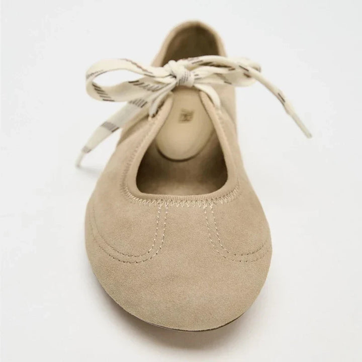 Detail shot of the laces on comfortable women's ballet flats, emphasizing secure fit and style.