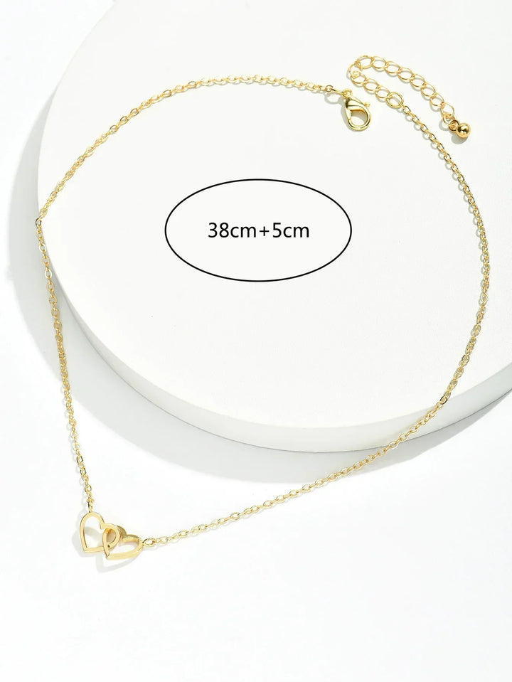 Women's gold vermeil interlocking heart pendant necklace elegantly displayed, highlighting its delicate sterling silver.