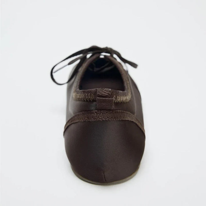 Comfortable women's ballet flats with sleek lace-up detail, suitable for dressy or casual style.