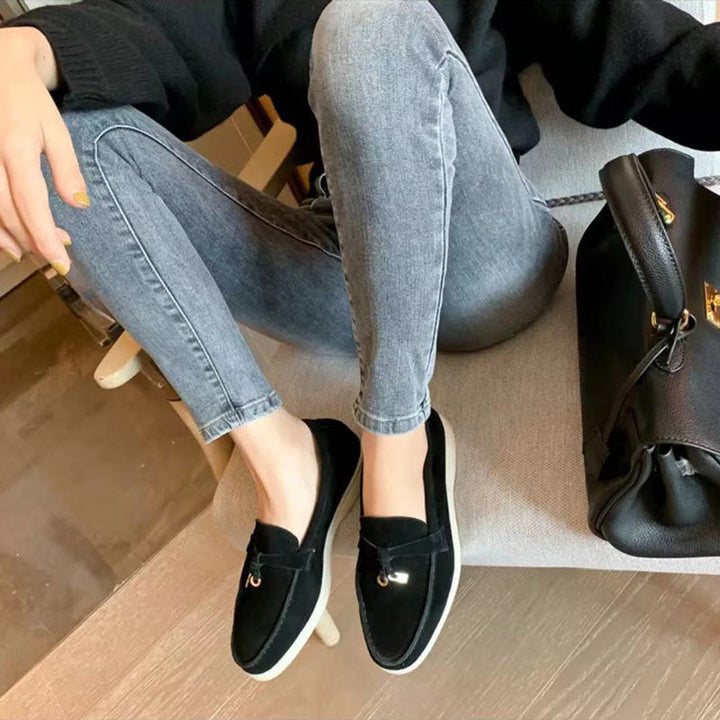Classic black pointed-toe slip-on loafers for women, offering sleek everyday style.