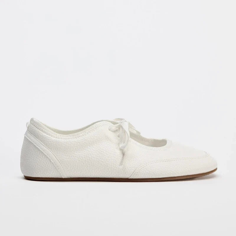 Close-up of women's comfortable black lace-up ballet flats for everyday style & versatile wear.