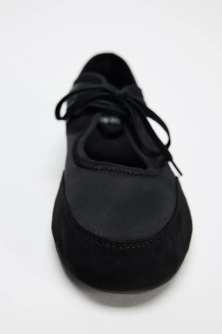 Women's fashionable lace-up ballet flats in a vibrant red, adding a pop of color to any look.