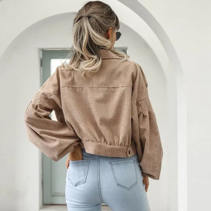 Stylish women's cropped corduroy bomber jacket, a casual outerwear essential with button closure.
