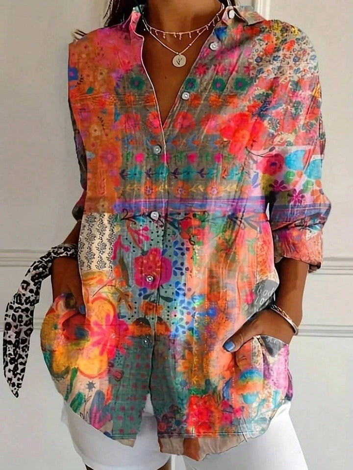 Ladies collared blouse with unique abstract print. Button-front, long sleeve top for a stylish, relaxed look.