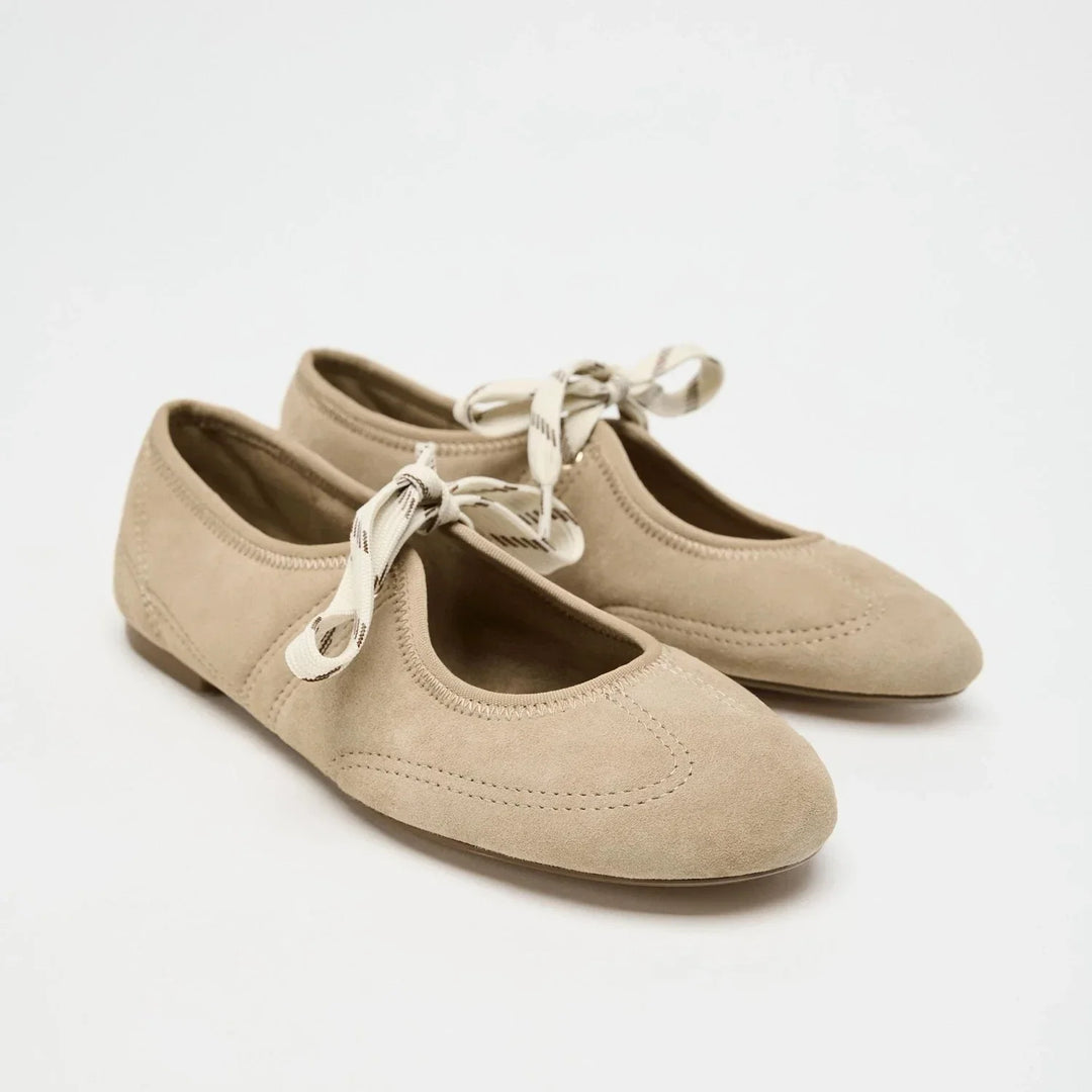 Women's chic lace-up ballet flats in a classic nude, essential for everyday and dressy outfits.