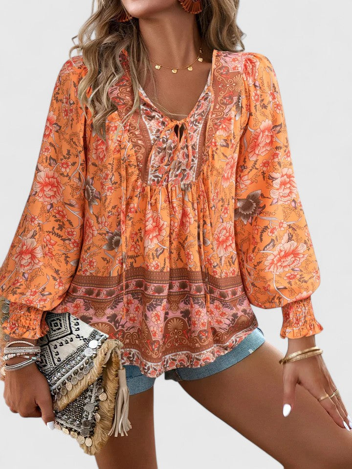 Flowy women's long sleeve boho top with relaxed fit & soft fabric. Stylish V-neck lace-up print blouse.