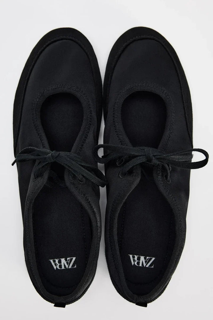 Elegant women's lace-up ballet flats, perfect for versatile styling and all-day comfort.