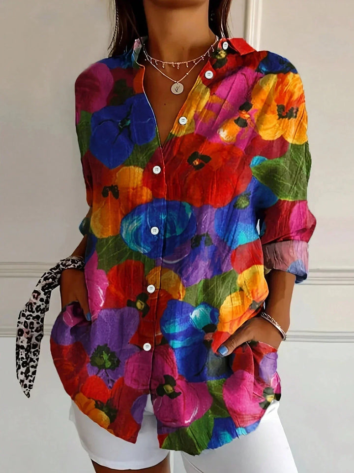 Fashionable ladies abstract print button-front blouse. Unique vibrant pattern, long sleeve, collared for style.